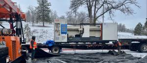 Image of the new laser being unloaded from the trailer that delivered it