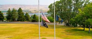 US and state of Oregon flags at half-staff
