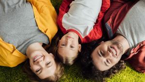 A happy family relaxing on the grass 