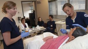 Nursing students learning how to intubate a patient