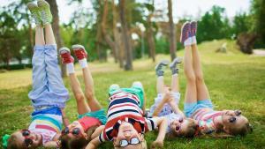 kids laying on their back on the grass and having fun at CGCC