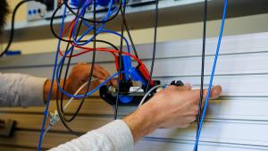 Student wiring a circuit board in a lab