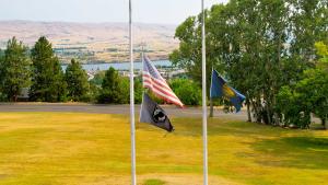 US and state of Oregon flags at half-staff